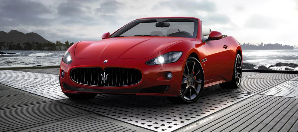Red Maserati convertible by the coast